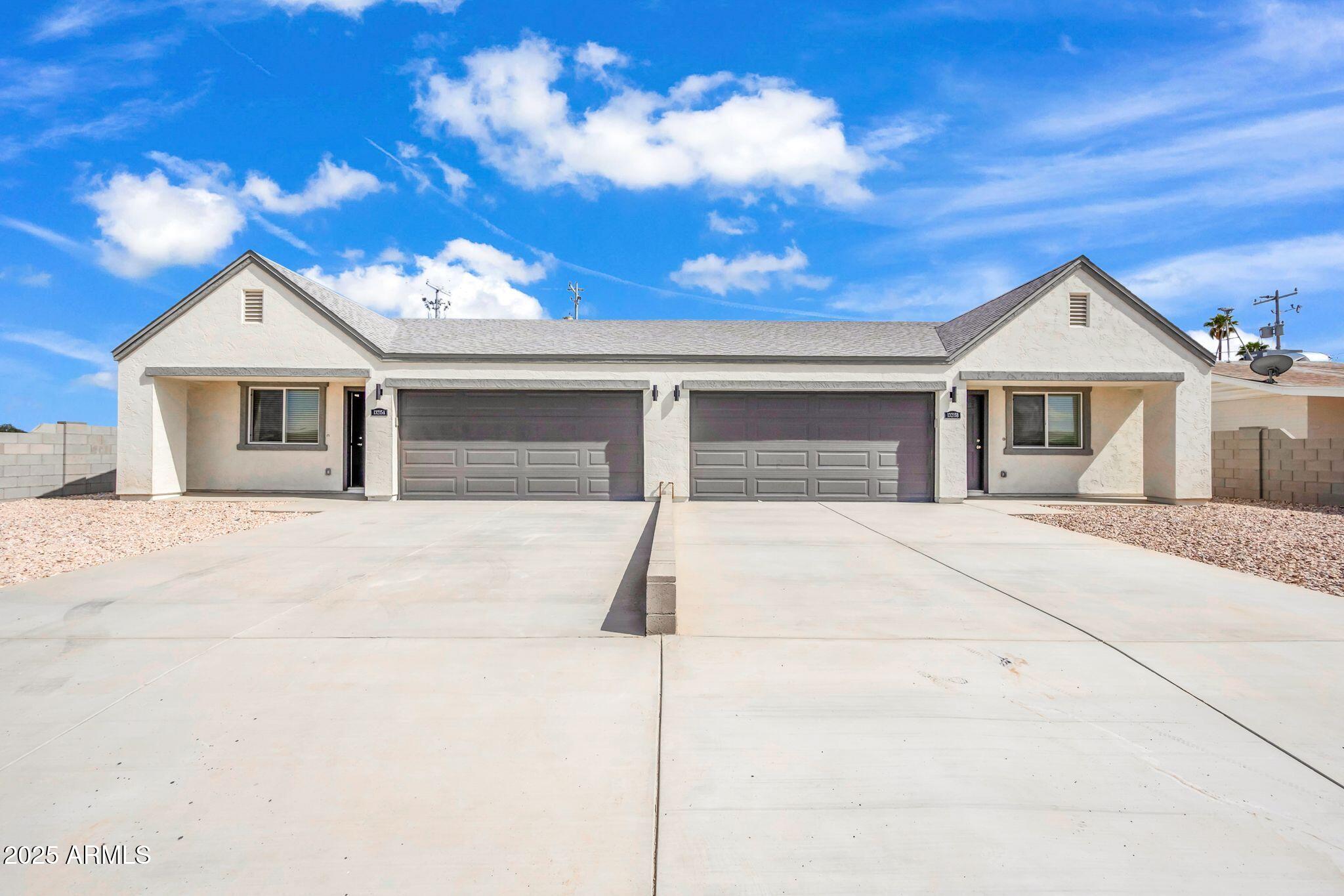 13215 South Laredo Road Arizona City, AZ 85123 - Photo 2 of 31 a front view of a house with a garage