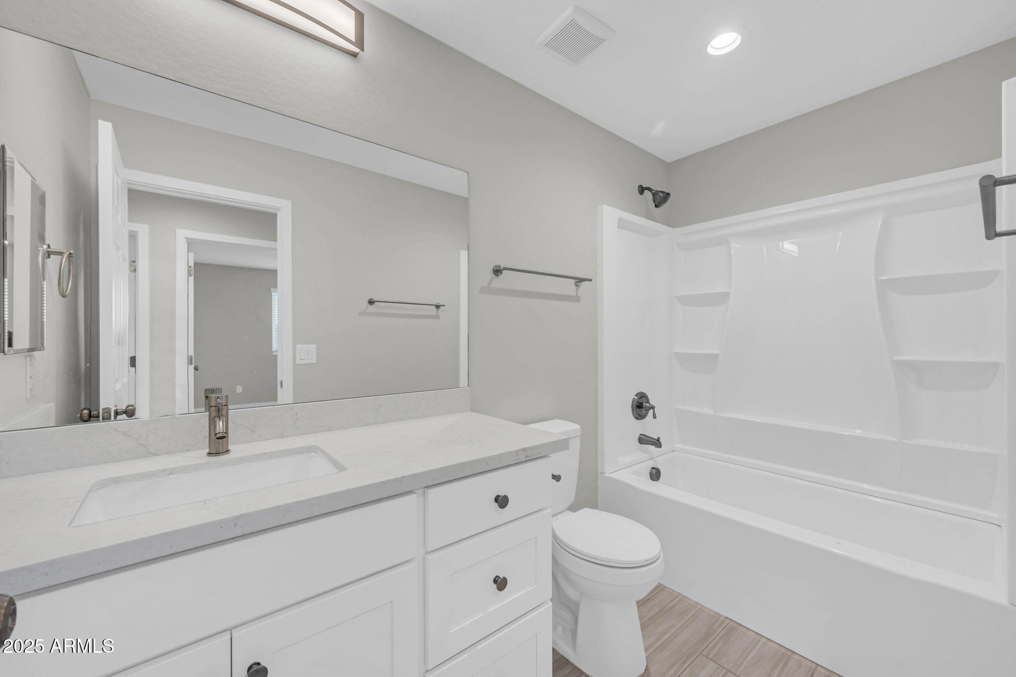 13215 South Laredo Road Arizona City, AZ 85123 - Photo 22 of 31 a bathroom with a sink a toilet and a large mirror