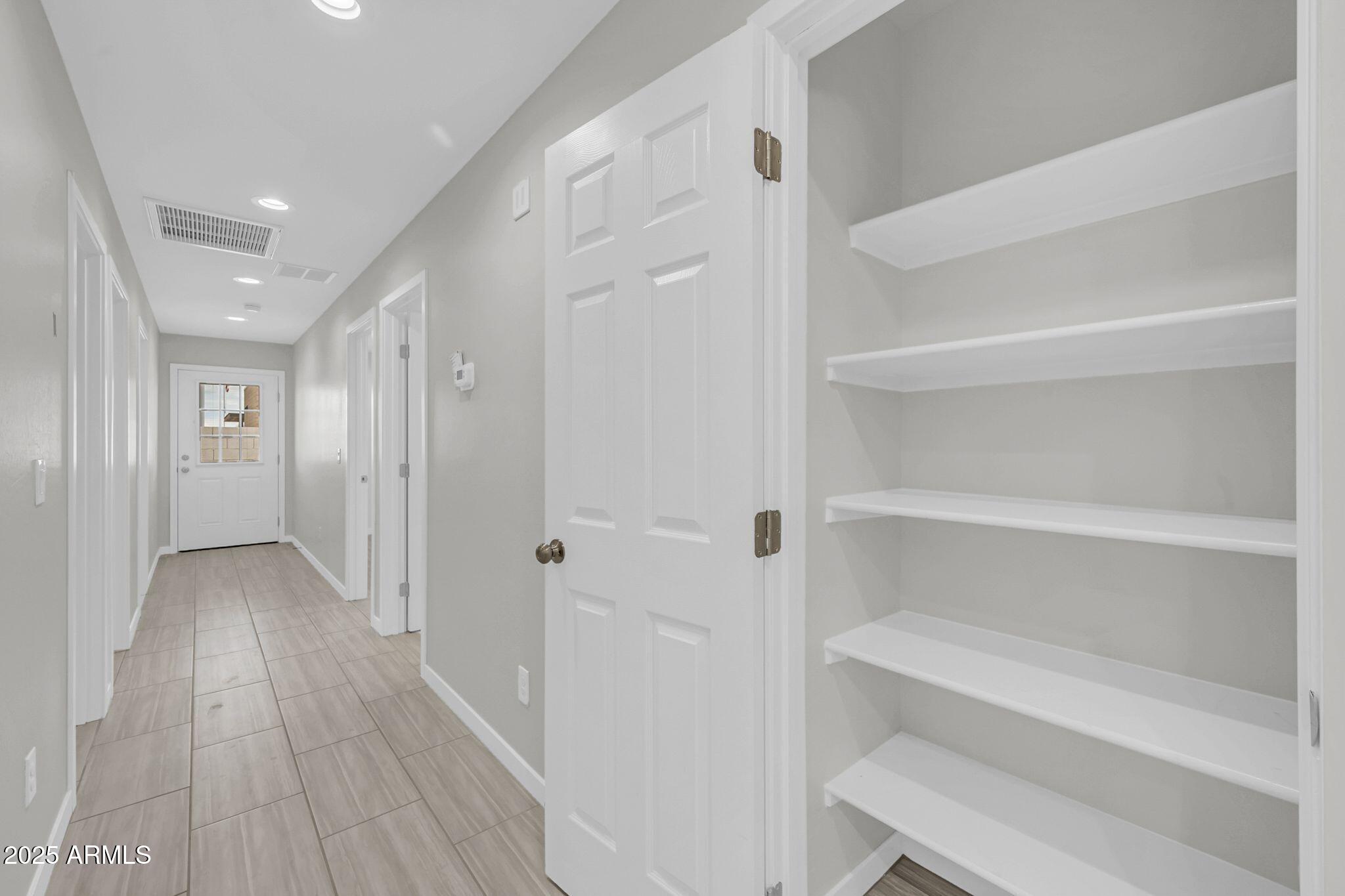 13215 South Laredo Road Arizona City, AZ 85123 - Photo 25 of 31 a view of a hallway with wooden floor
