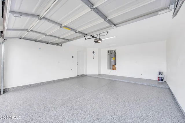 an empty room with a ceiling fan and wooden floor