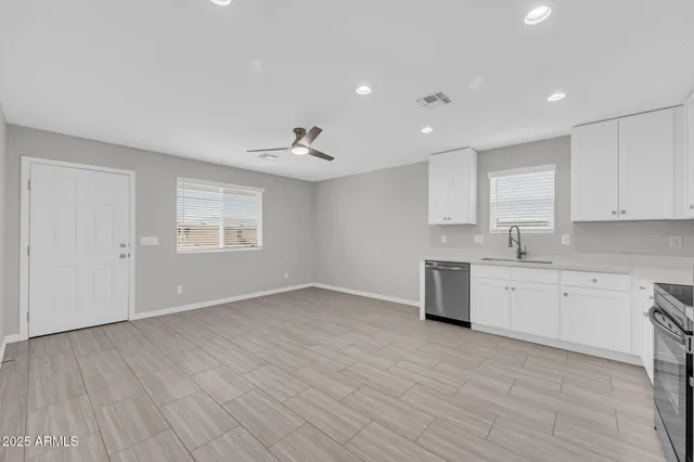 a view of a kitchen with sink cabinets and wooden floor
