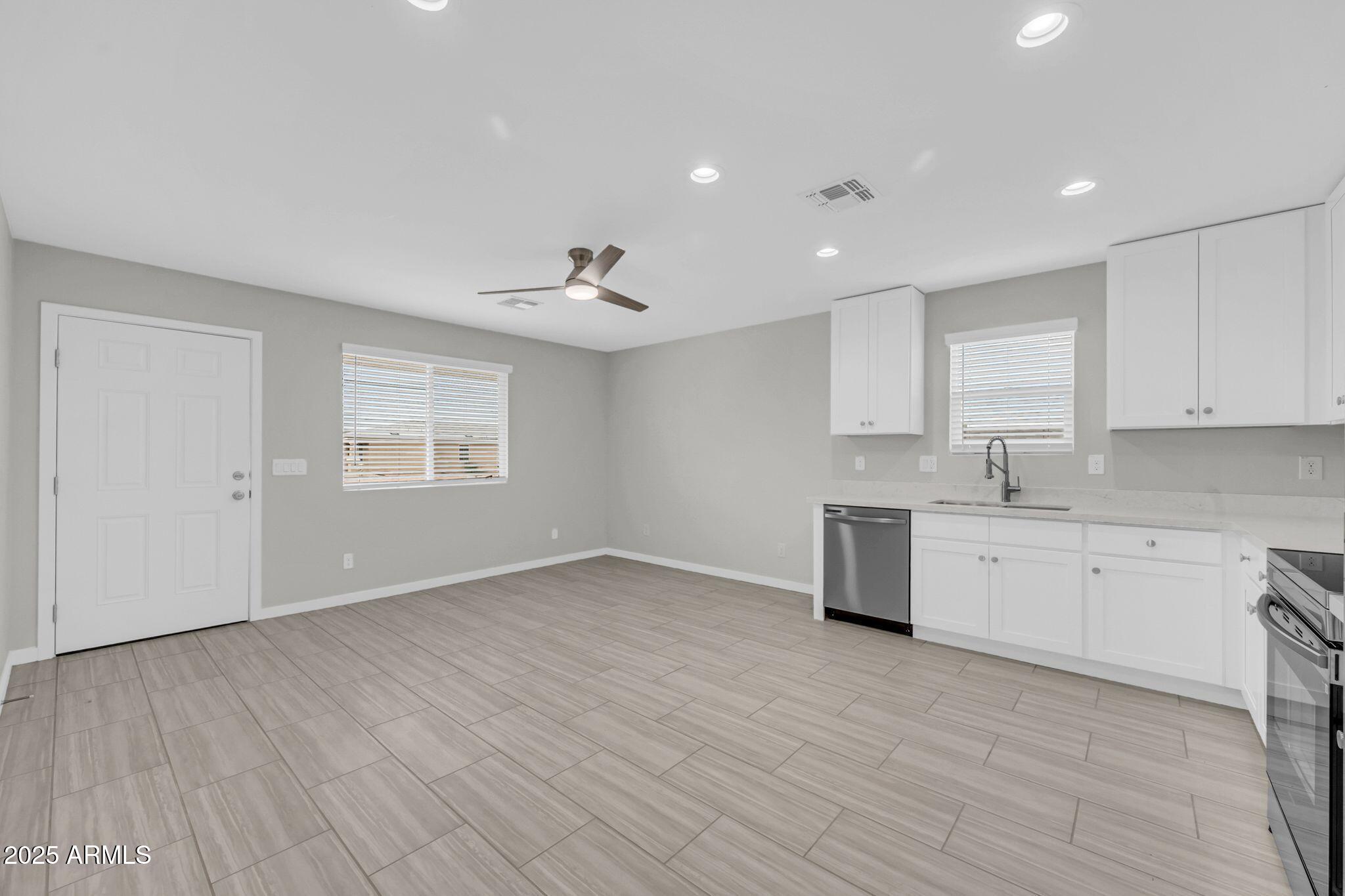 13215 South Laredo Road Arizona City, AZ 85123 - Photo 5 of 31 a view of a kitchen with sink cabinets and wooden floor