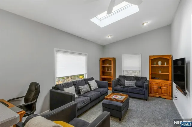 a bathroom with a granite countertop sink toilet a mirror and shower