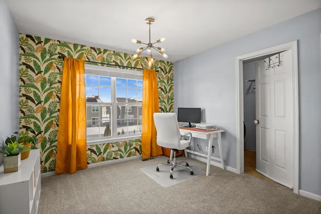 a view of a dining room with a table and chairs