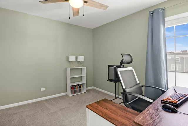 a view of a workspace with furniture and windows