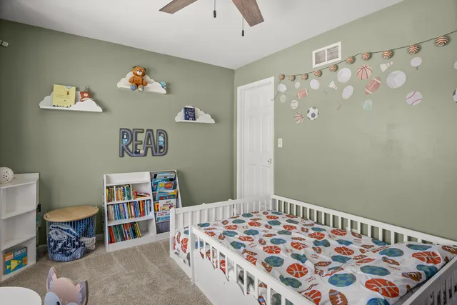 a bedroom with a bed and a bookshelf