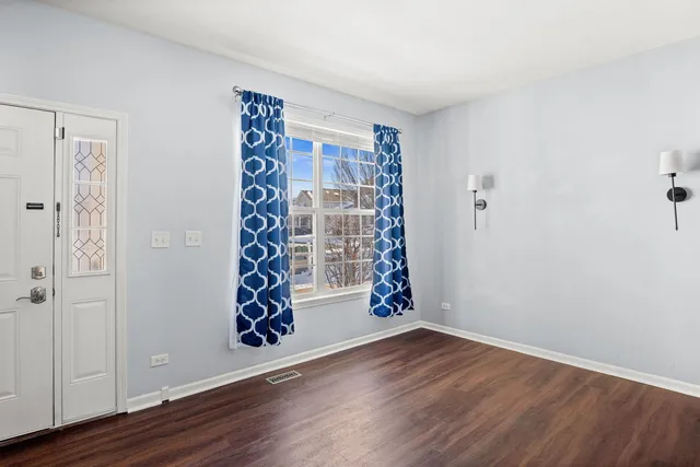 a view of an entryway with wooden floor
