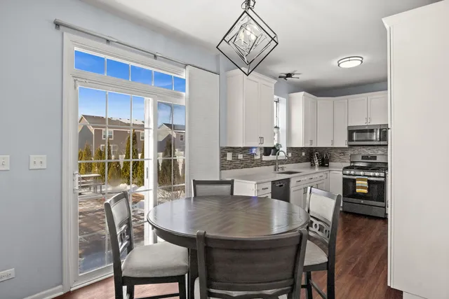 a view of a dining room with furniture wooden floor and chandelier