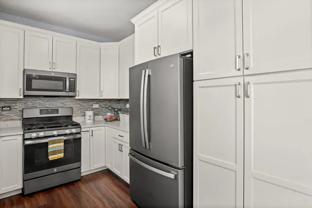 a kitchen with stainless steel appliances a refrigerator stove and microwave