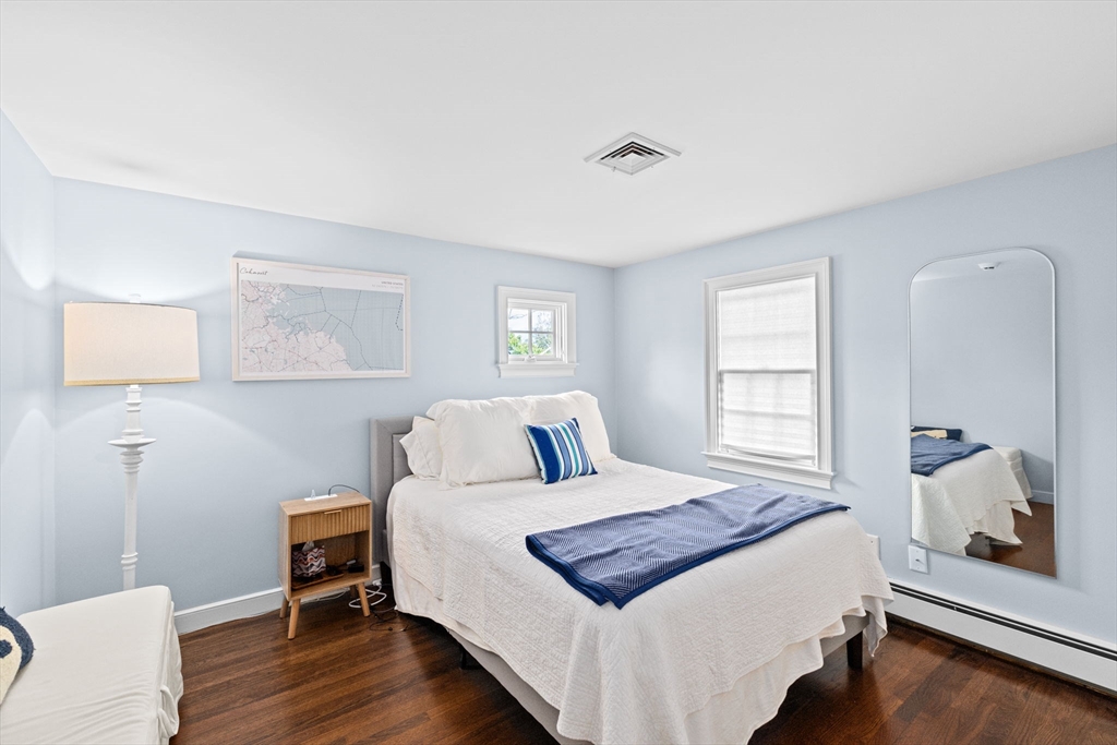 101 Nichols Road Cohasset, MA 02025 - Photo 20 of 34 a bedroom with a bed and a lamp