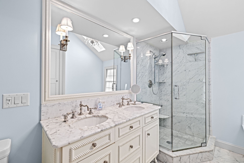 101 Nichols Road Cohasset, MA 02025 - Photo 24 of 34 a bathroom with a granite countertop sink a mirror a shower and a bathtub