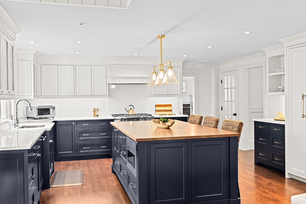 101 Nichols Road Cohasset, MA 02025 - Photo 8 of 34 a kitchen with stainless steel appliances granite countertop a sink stove and refrigerator