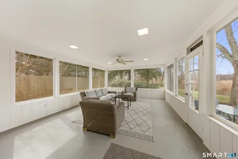 a living room with furniture and large windows