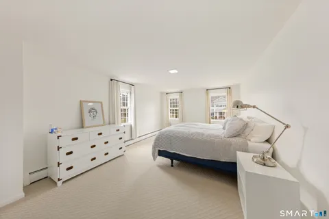 a large white bed in a white room