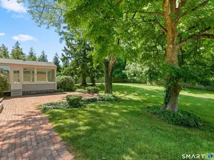 an aerial view of a house with a yard swimming pool and outdoor seating