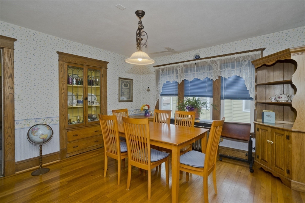 22-24 Eldridge Street Springfield, MA 01108 - Photo 11 of 41 a view of a dining room with furniture and wooden floor