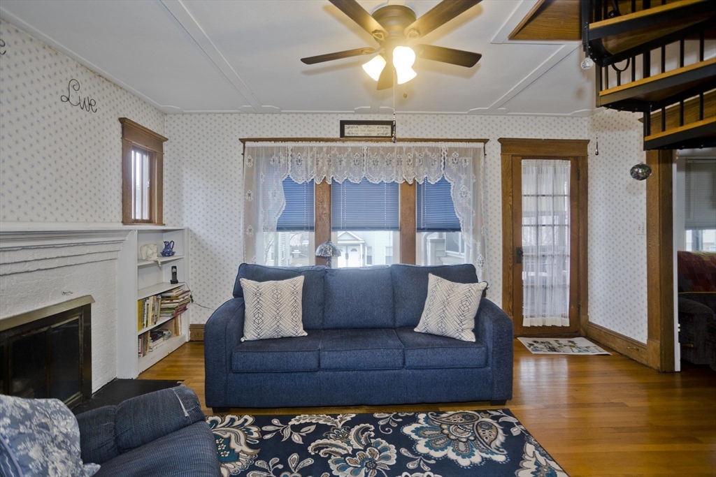 22-24 Eldridge Street Springfield, MA 01108 - Photo 14 of 41 a living room with furniture and a fireplace