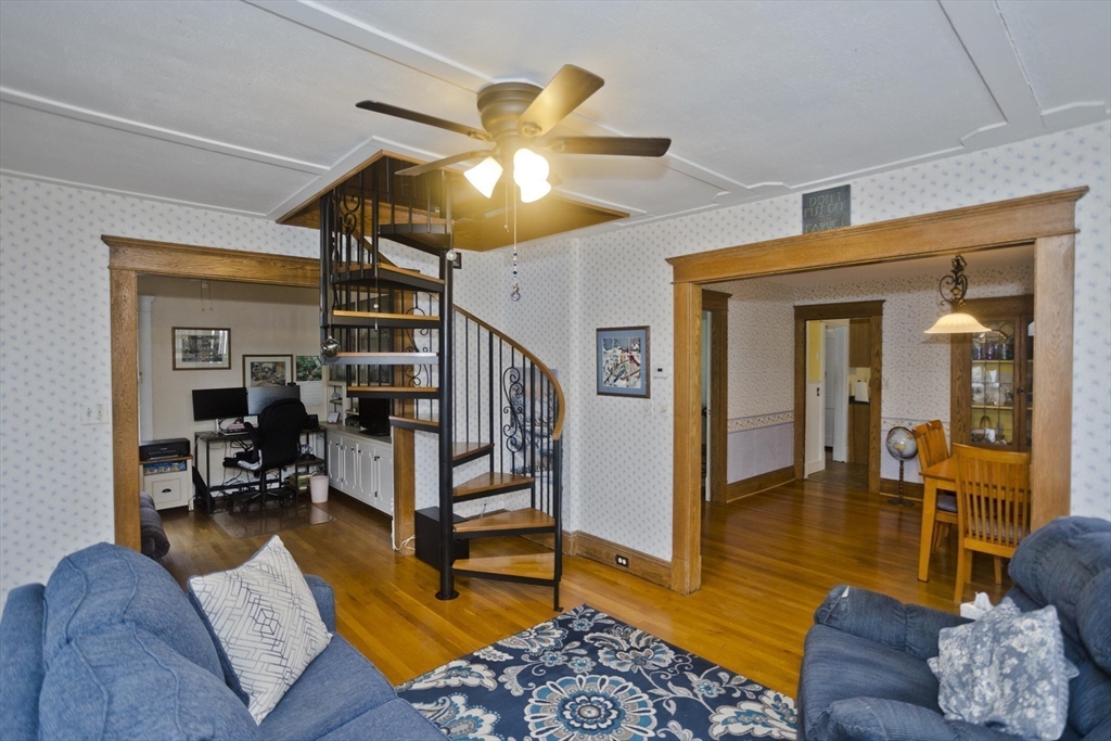 22-24 Eldridge Street Springfield, MA 01108 - Photo 16 of 41 a living room with furniture ceiling fan and a rug