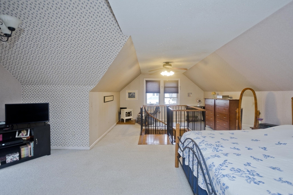 22-24 Eldridge Street Springfield, MA 01108 - Photo 26 of 41 a bedroom with a bed and a flat tv screen on wall