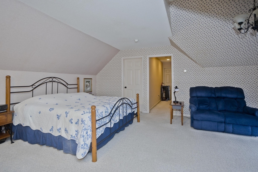 22-24 Eldridge Street Springfield, MA 01108 - Photo 28 of 41 a spacious bedroom with a bed and a dresser