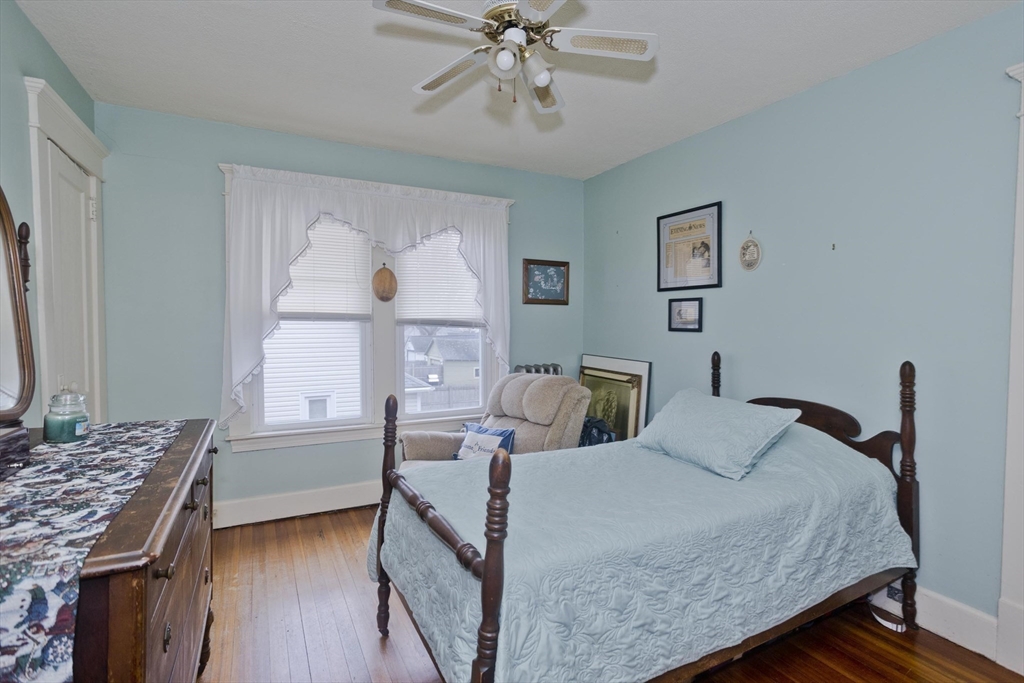 22-24 Eldridge Street Springfield, MA 01108 - Photo 31 of 41 a bedroom with a bed and a chandelier