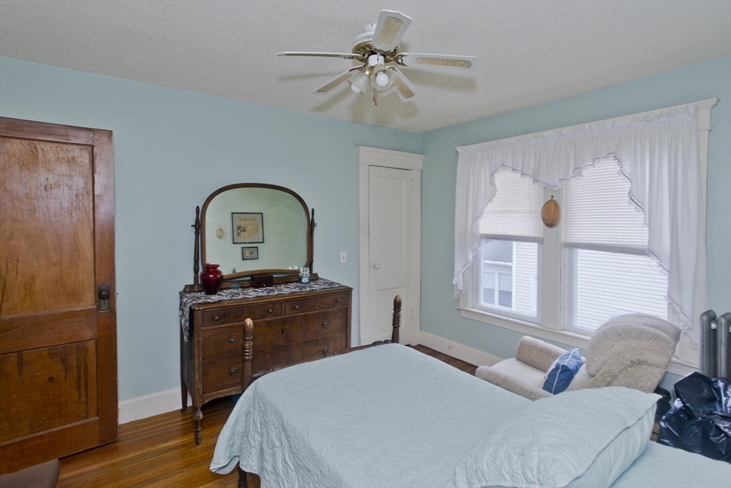 22-24 Eldridge Street Springfield, MA 01108 - Photo 33 of 41 a bedroom with a bed and a chandelier