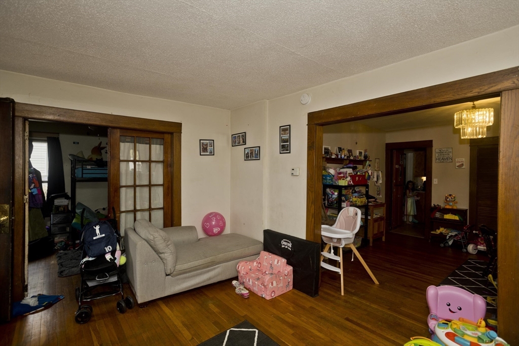 22-24 Eldridge Street Springfield, MA 01108 - Photo 37 of 41 a living room with furniture and a wooden floor