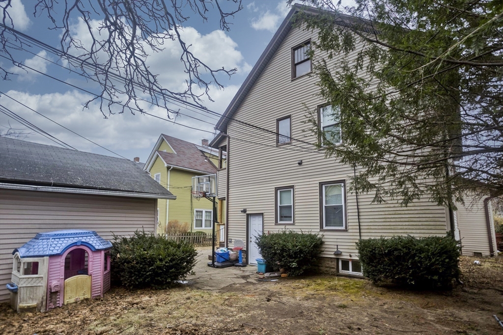 22-24 Eldridge Street Springfield, MA 01108 - Photo 4 of 41 a view of a house with a yard and plants
