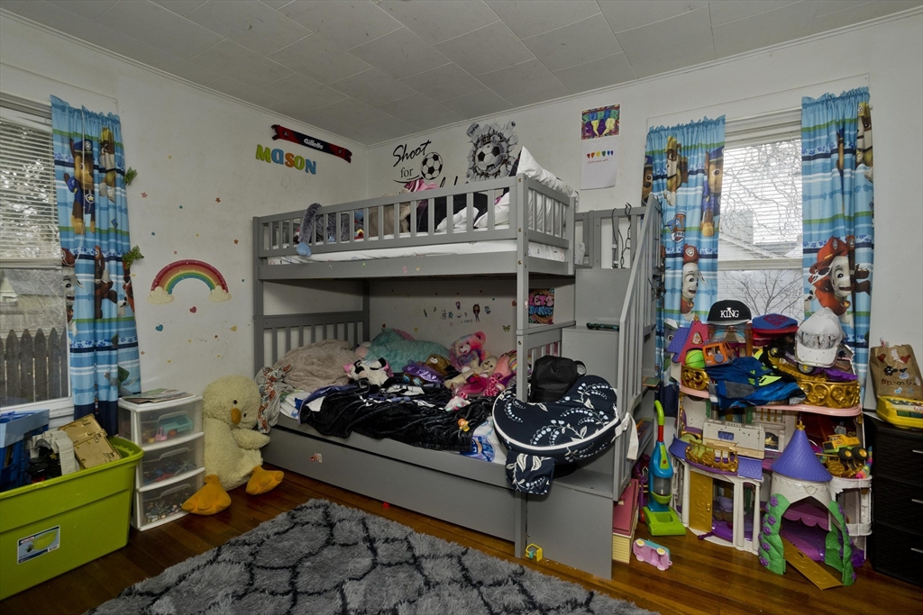 22-24 Eldridge Street Springfield, MA 01108 - Photo 41 of 41 a living room with lots of baby toys and a baby crib