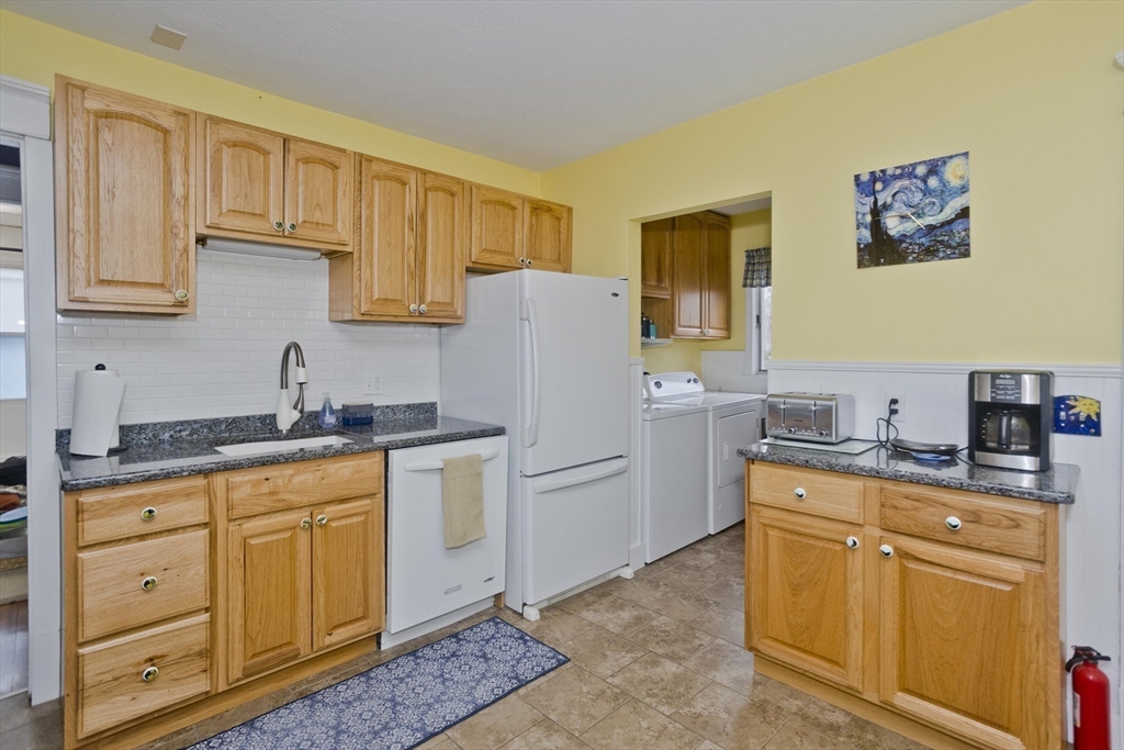 22-24 Eldridge Street Springfield, MA 01108 - Photo 6 of 41 a kitchen with stainless steel appliances granite countertop a refrigerator sink and cabinets
