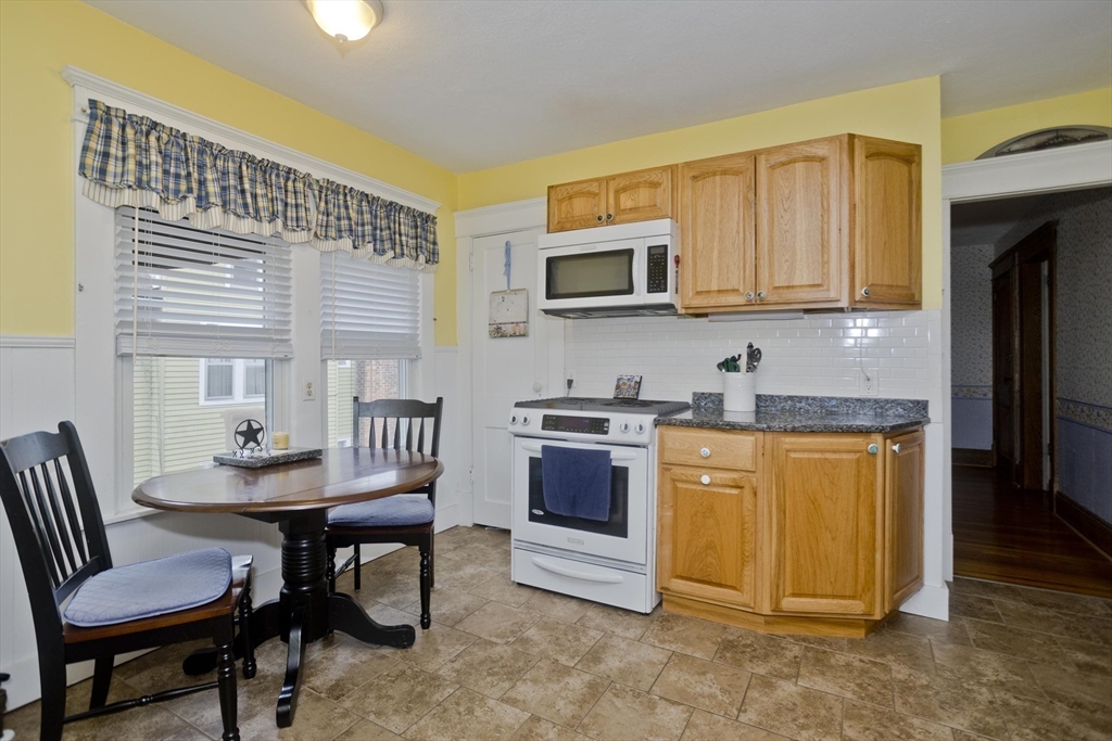 22-24 Eldridge Street Springfield, MA 01108 - Photo 9 of 41 a kitchen with stainless steel appliances granite countertop a stove a sink a microwave and a refrigerator