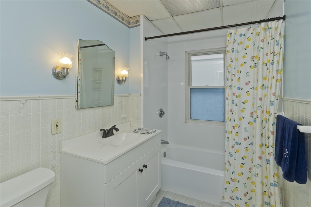 22-24 Eldridge Street Springfield, MA 01108 - Photo 10 of 41 a bathroom with a sink a toilet a shower curtain and a bath tub