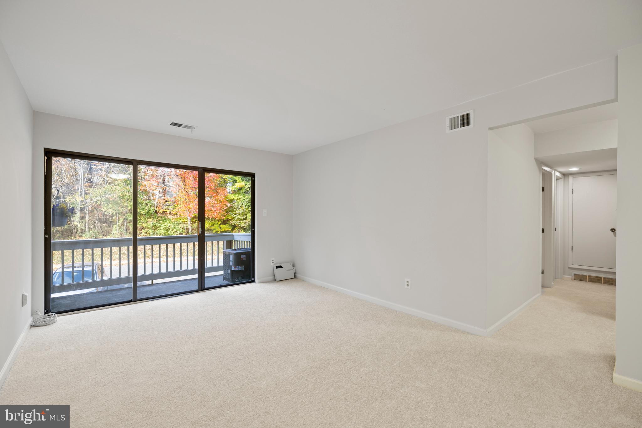 5821 Royal Ridge Drive, Unit E Springfield, VA 22152 - Photo 5 of 18 Deck off the living room opening to wooded view