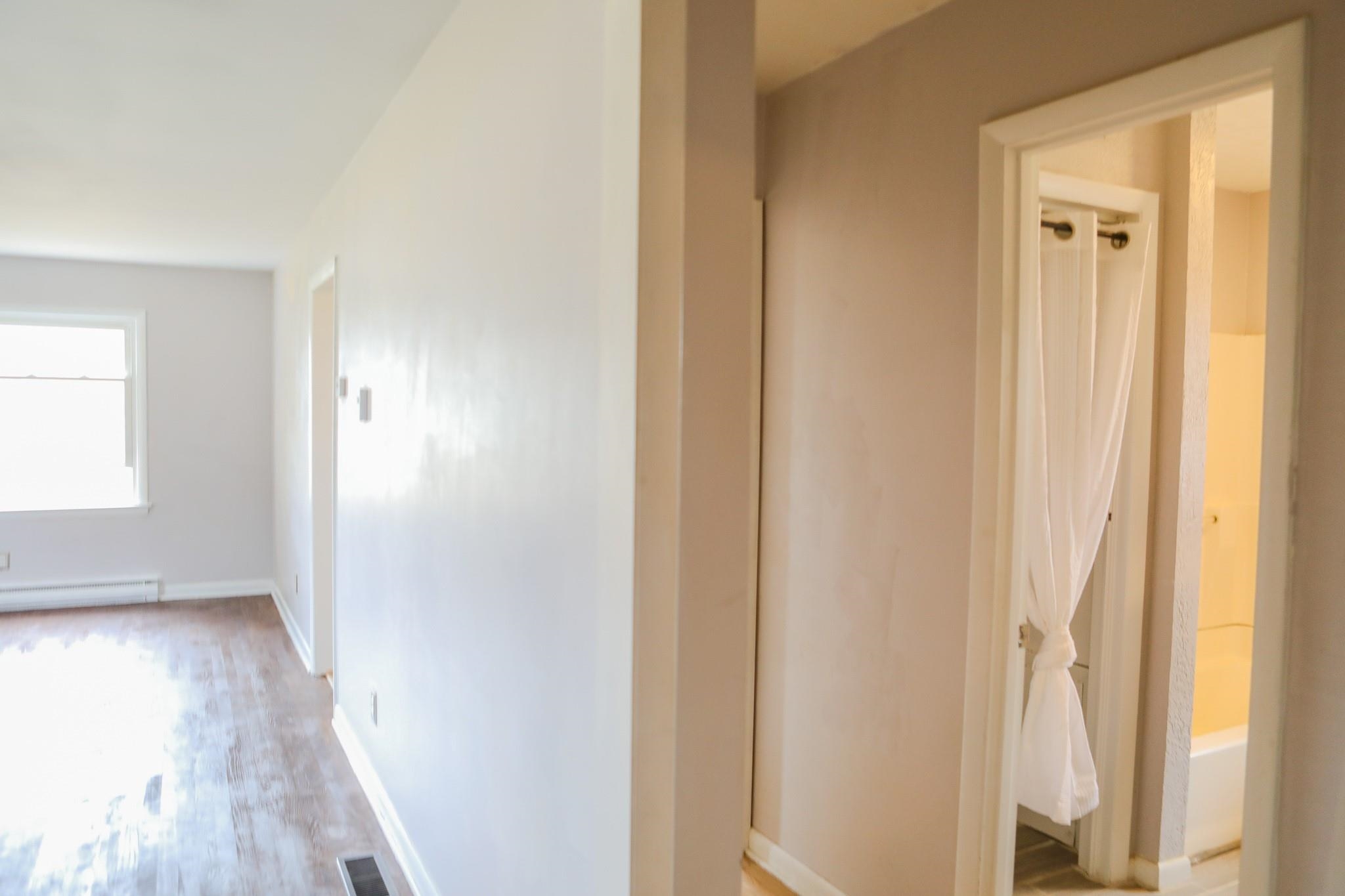 1613 Howardsville Road Staunton, VA 24401 - Photo 23 of 41 a view of a hallway with wooden floor and a bathroom