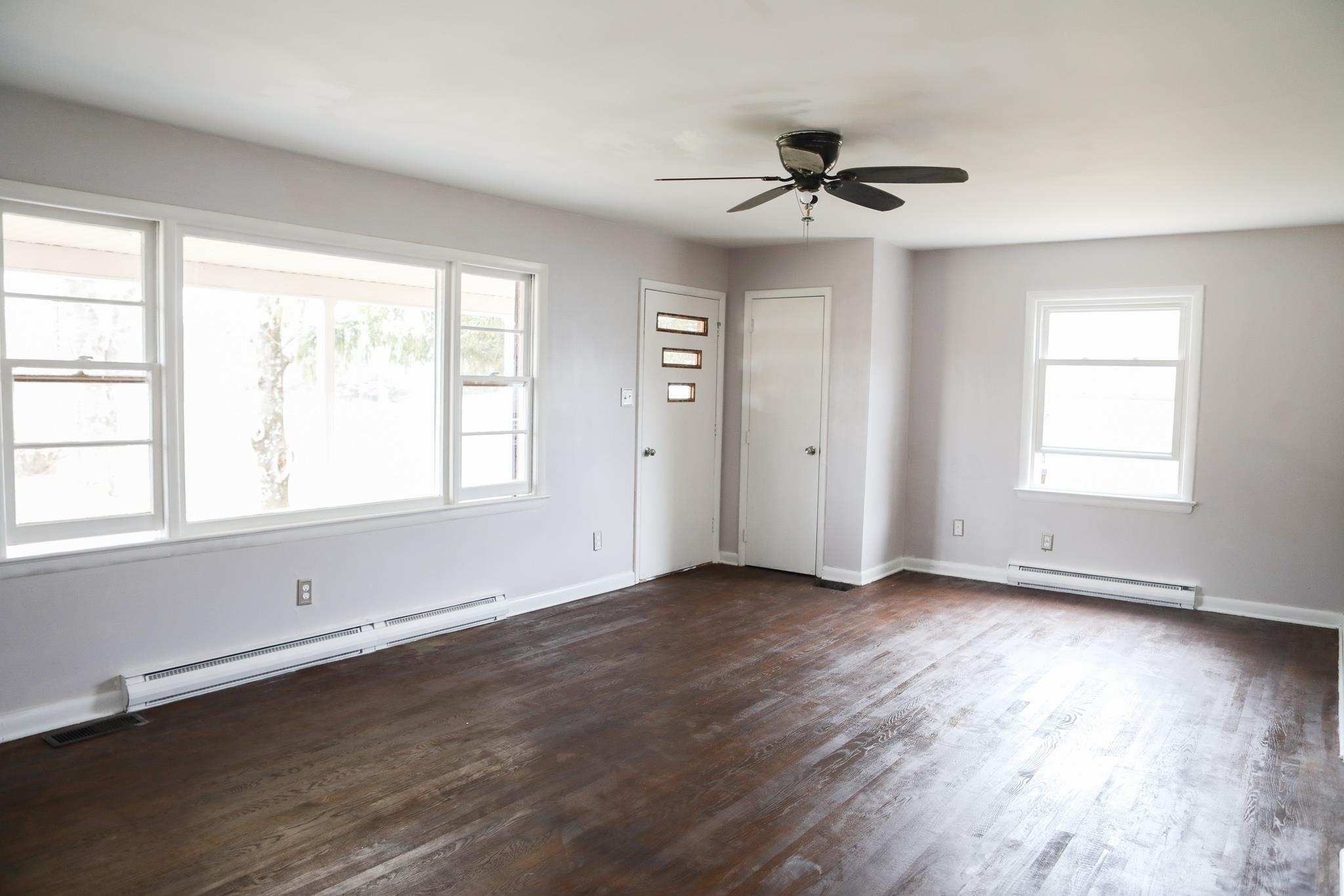 1613 Howardsville Road Staunton, VA 24401 - Photo 5 of 41 a view of an empty room with wooden floor and a window