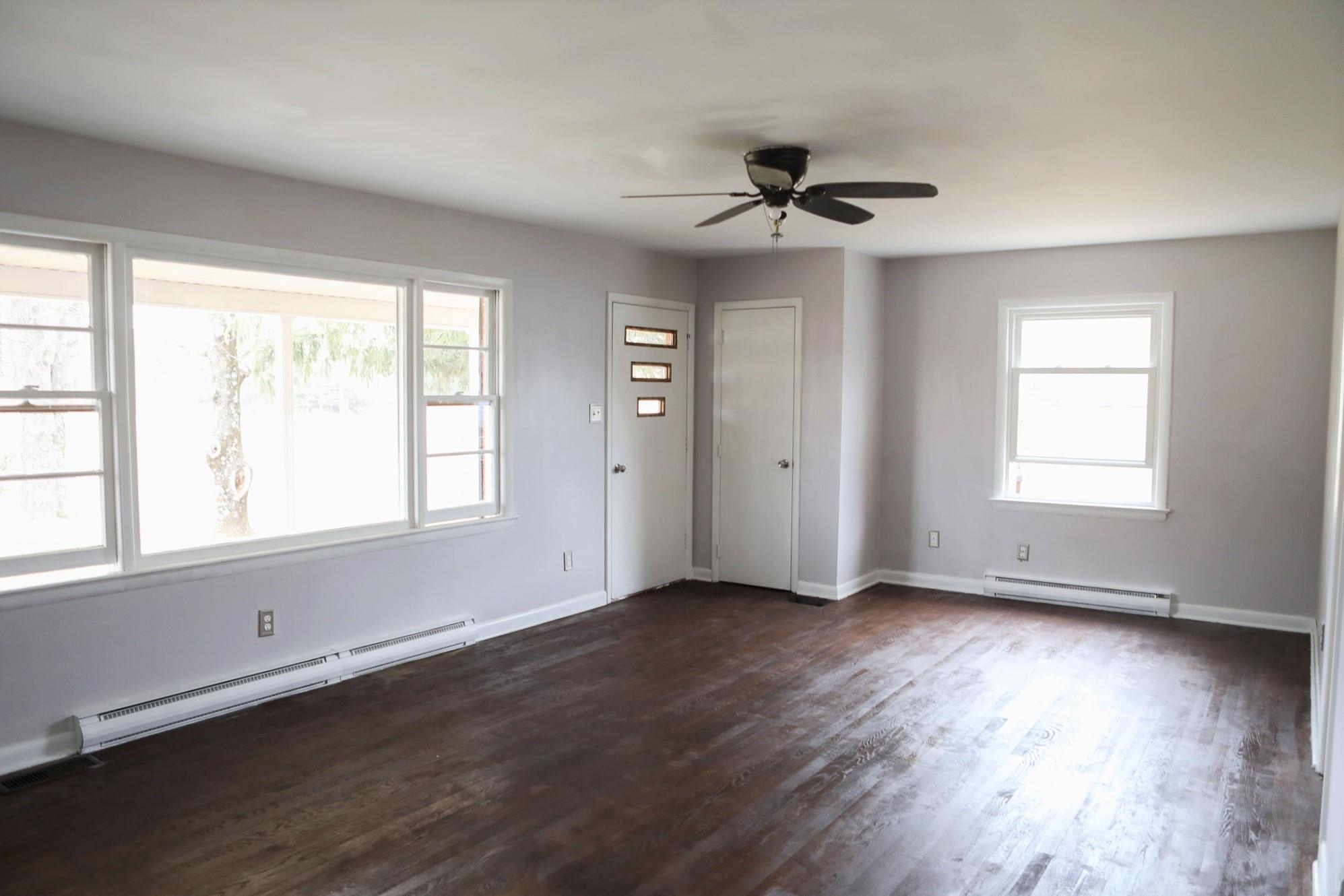 1613 Howardsville Road Staunton, VA 24401 - Photo 6 of 41 a view of an empty room with wooden floor and a window
