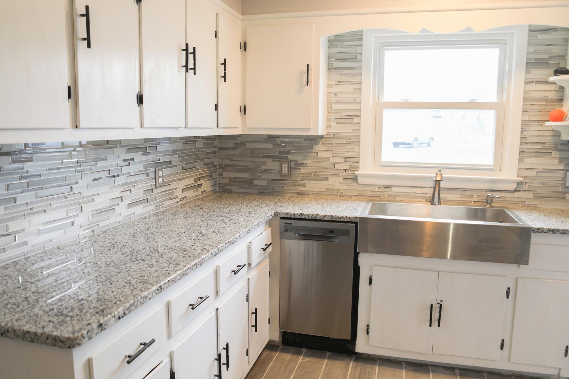 1613 Howardsville Road Staunton, VA 24401 - Photo 9 of 41 a kitchen with granite countertop white cabinets and sink