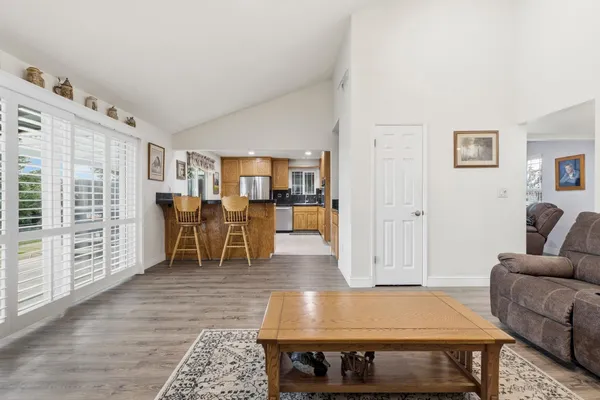 a living room with furniture a dining table and with wooden floor