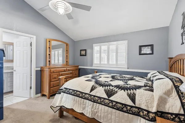 a bedroom with a bed and a table in it