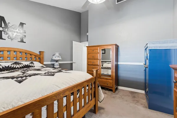 a bedroom with a bed and a dresser