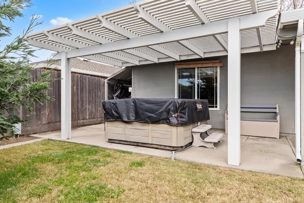 a view of a patio with table and chairs near a yard