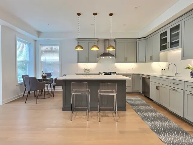 a kitchen with a sink a counter space appliances and cabinets