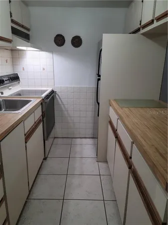 a kitchen with a cabinets and a stove top oven