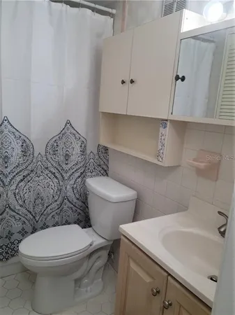 a white toilet sitting next to a bathroom sink