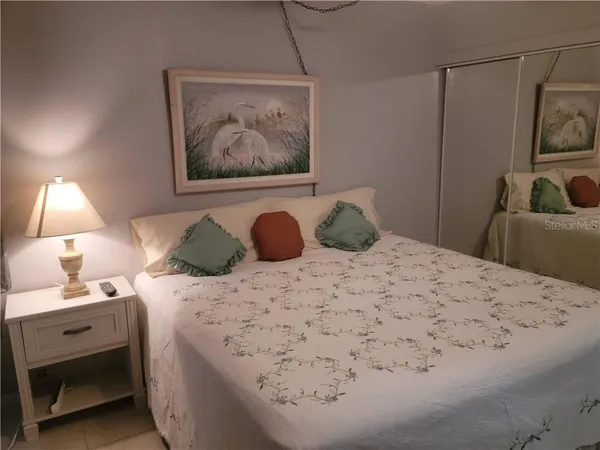 a bedroom with a bed and a lamp