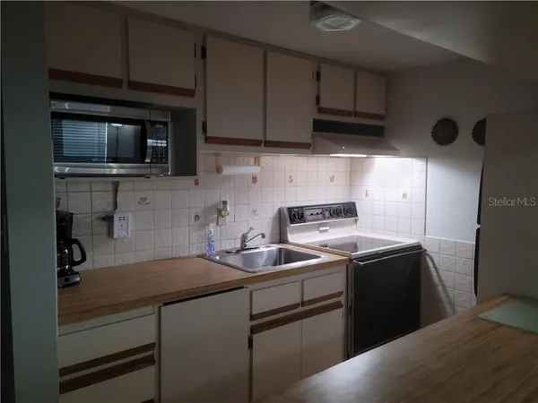 a kitchen with a sink and cabinets