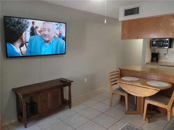 a room with furniture and a potted plant