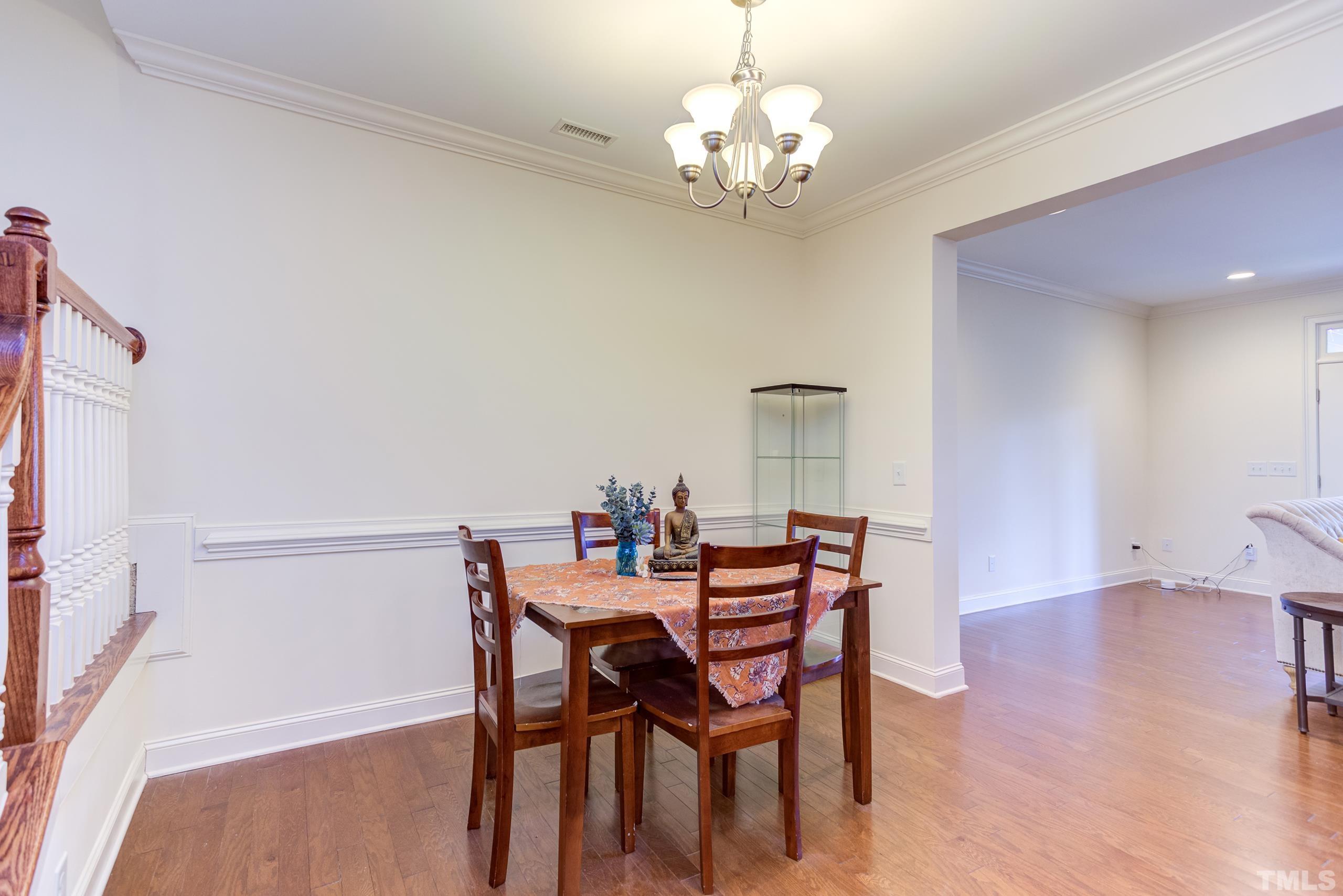 449 Talons Rest Way Cary, NC 27513 - Photo 13 of 54 a view of a dining room with furniture and wooden floor