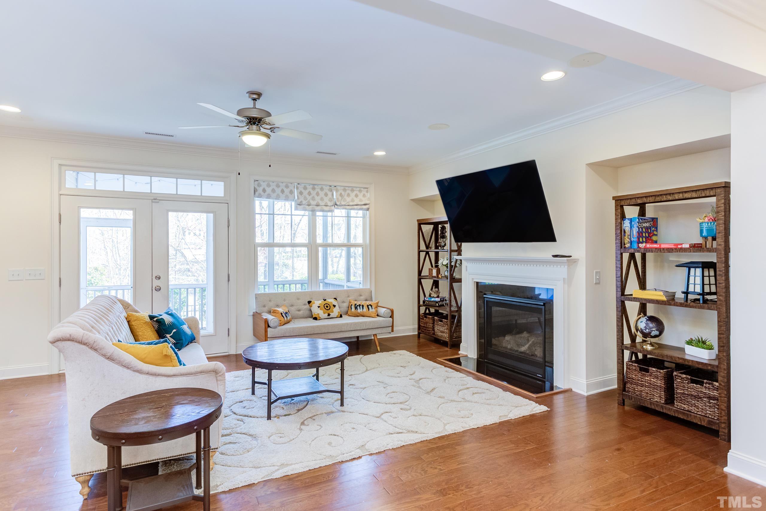 449 Talons Rest Way Cary, NC 27513 - Photo 15 of 54 a living room with furniture a fireplace and a flat screen tv
