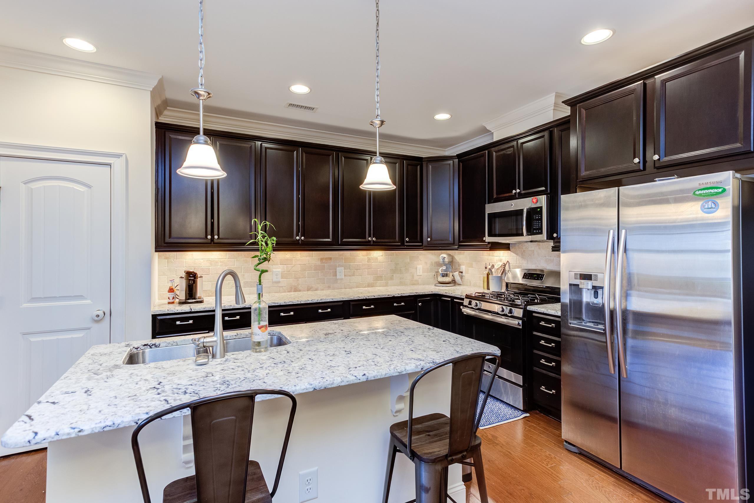 449 Talons Rest Way Cary, NC 27513 - Photo 16 of 54 a kitchen with granite countertop a sink and refrigerator